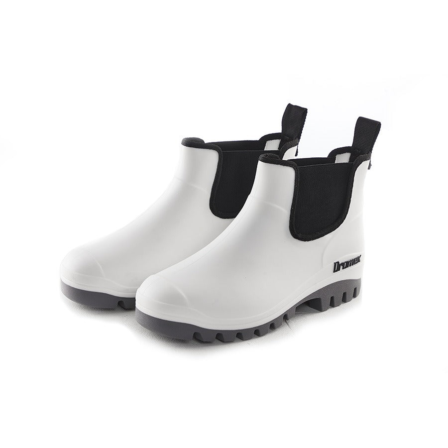 White rain boots with black soles on a white background
